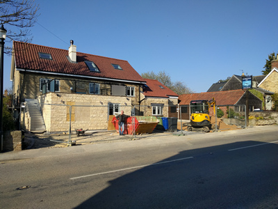 Ext. Day. Pub. Constructing and glazing the Edge Protection.