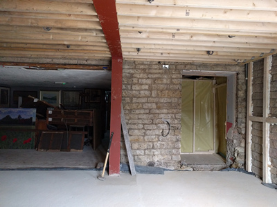 Int. Day. Pub. The 'First fix' is complete — the space is ready for the walls to be plastered.