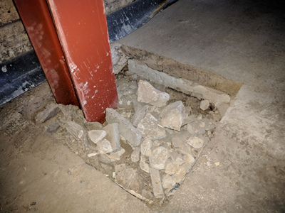 Int. Day. Pub. The Rolled Steel Joist where it is bedded into the foundation — also visible is the insulation material beneath the floor slab.