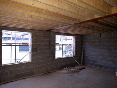 Int. Day. Pub. Interior of the room looking South West. The floor to the flat roof has been boarded.
