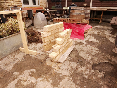 Ext.Day. Pub. A small section of stone walling as sample for the finished building.